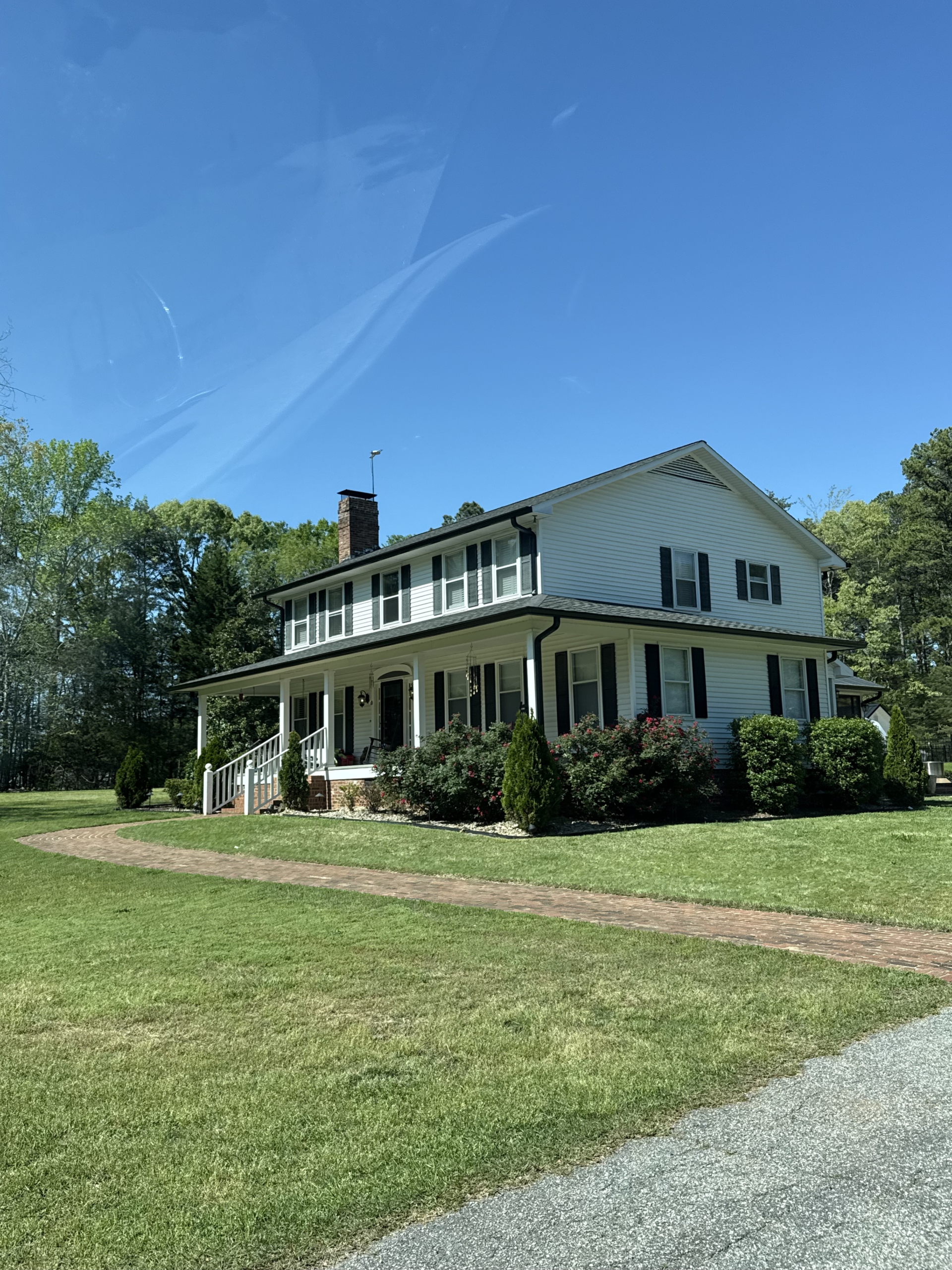Two-story white house with lawn | GutterCo logo (Gutter) (Gallery)