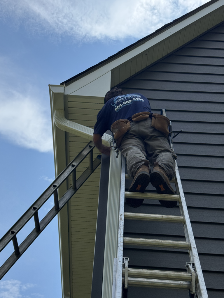 Worker climbing a ladder | GutterCo (Gutter Repair)